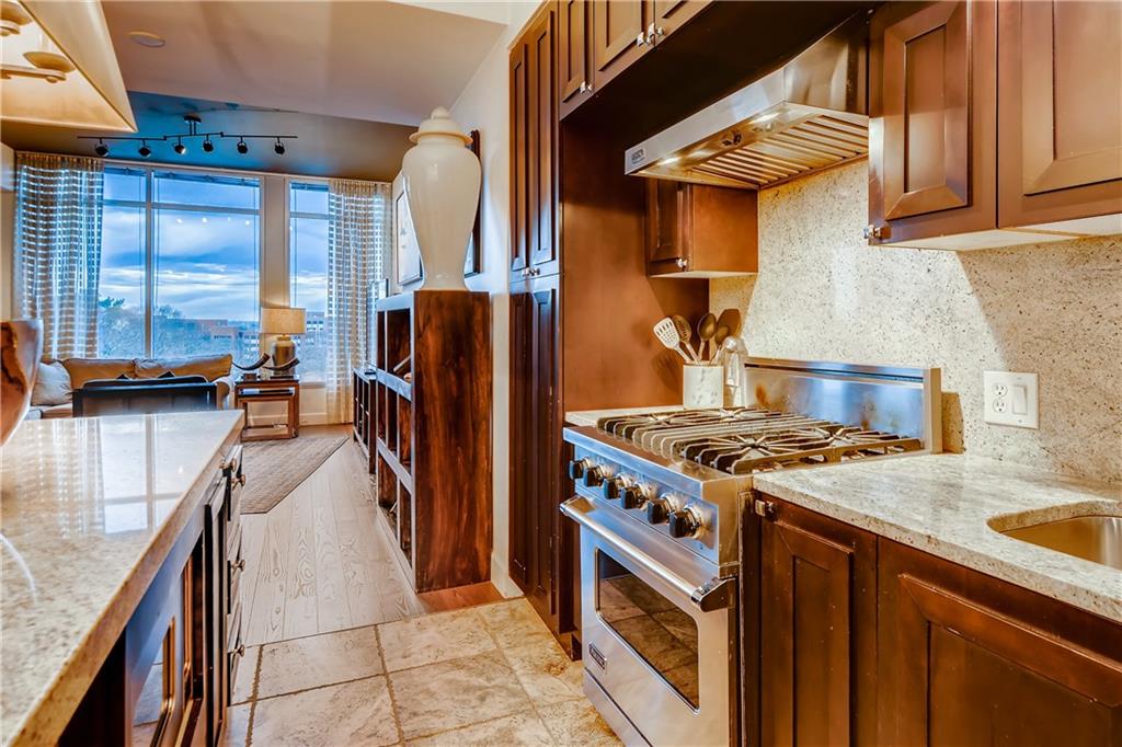 1820 Peachtree Road Northwest, Unit 811 Atlanta, GA 30309 - Photo 10 of 42 a kitchen with stainless steel appliances granite countertop a stove a refrigerator and a sink