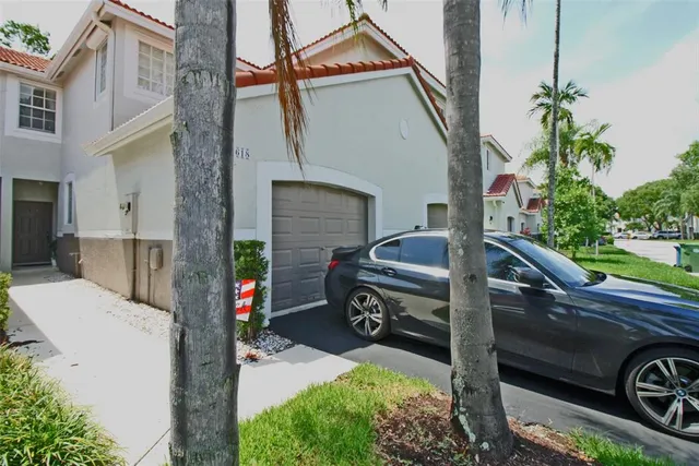 a view of a patio with two chairs and a cycle