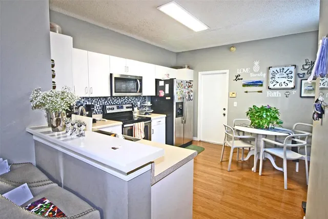 a kitchen with a table and chairs in it