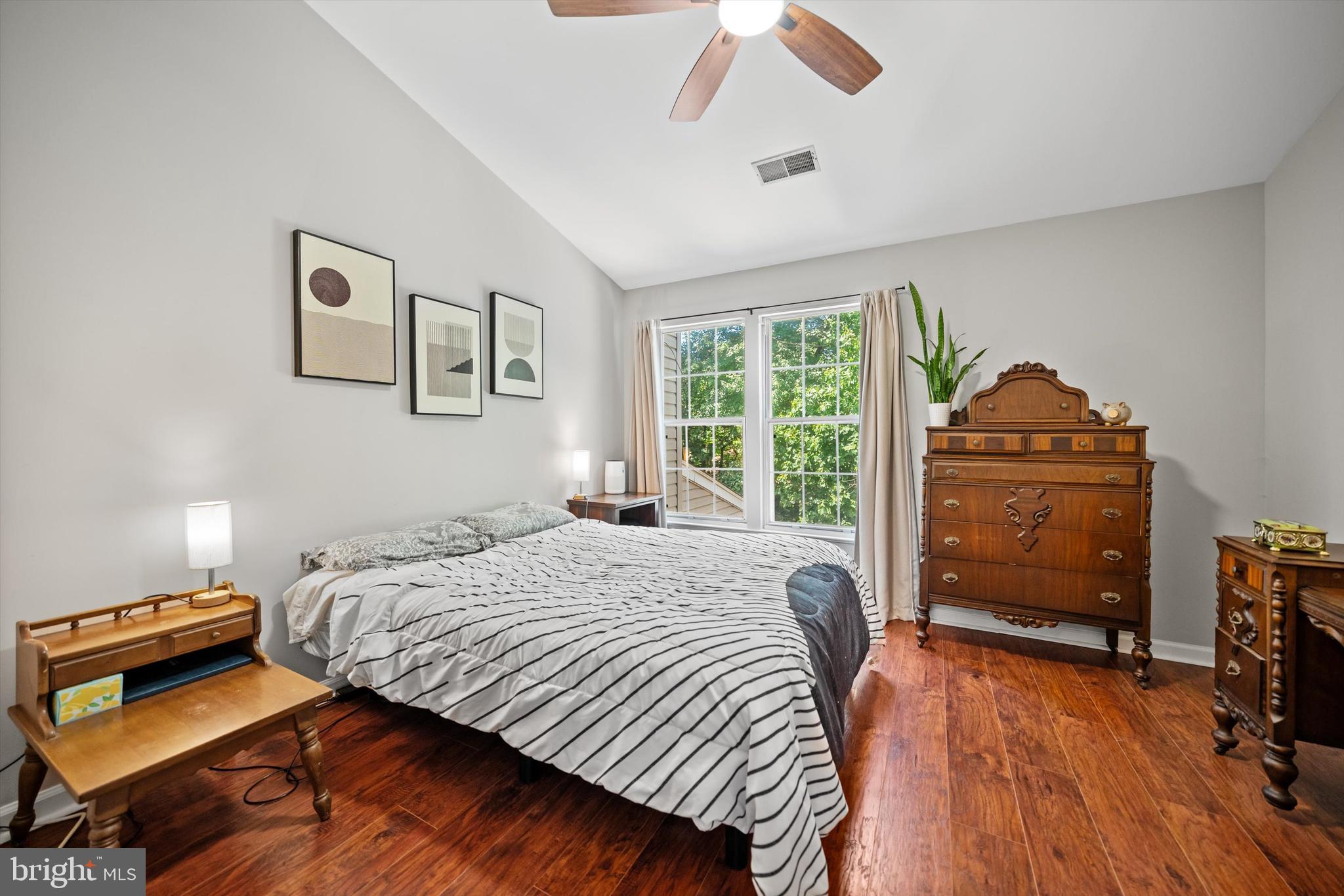 12794 Silvia Loop Woodbridge, VA 22192 - Photo 13 of 24 a bedroom with a bed and a dresser next to a window