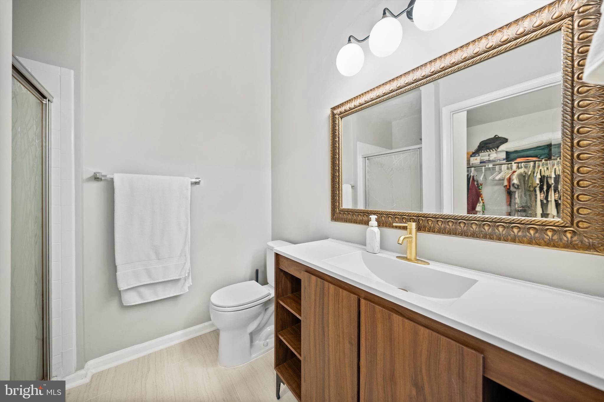 12794 Silvia Loop Woodbridge, VA 22192 - Photo 15 of 24 a bathroom with a sink a toilet and a mirror