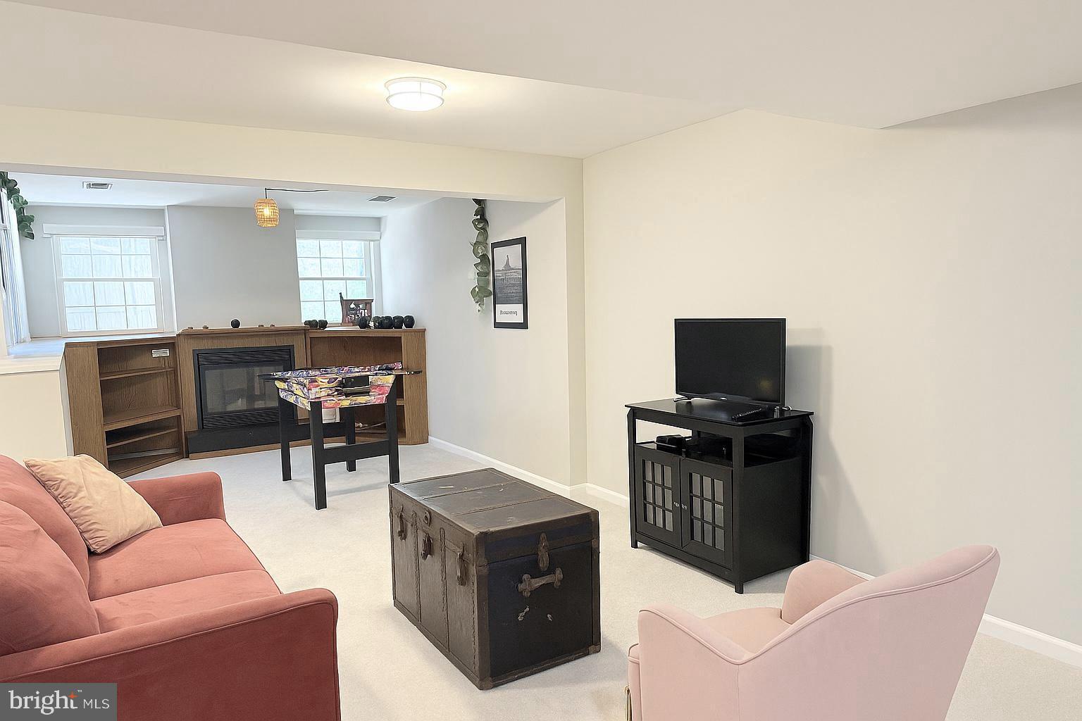 12794 Silvia Loop Woodbridge, VA 22192 - Photo 20 of 24 a living room with furniture a flat screen tv and wooden floor