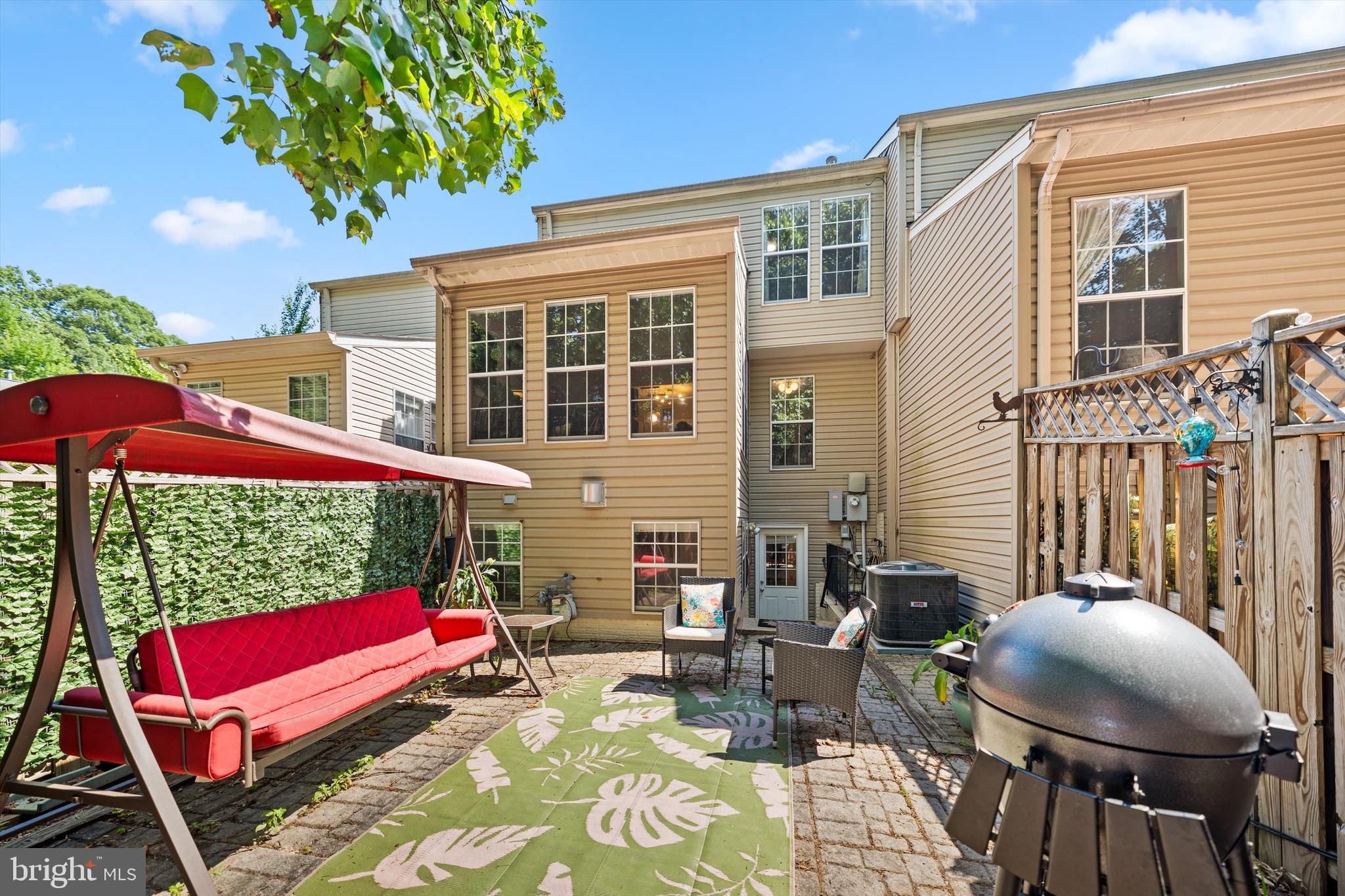 12794 Silvia Loop Woodbridge, VA 22192 - Photo 24 of 24 a view of a patio with a table and chairs under an umbrella