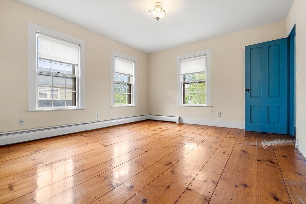 1 Red Frank Lane Marblehead, MA 01945 - Photo 22 of 32 an empty room with wooden floor and windows