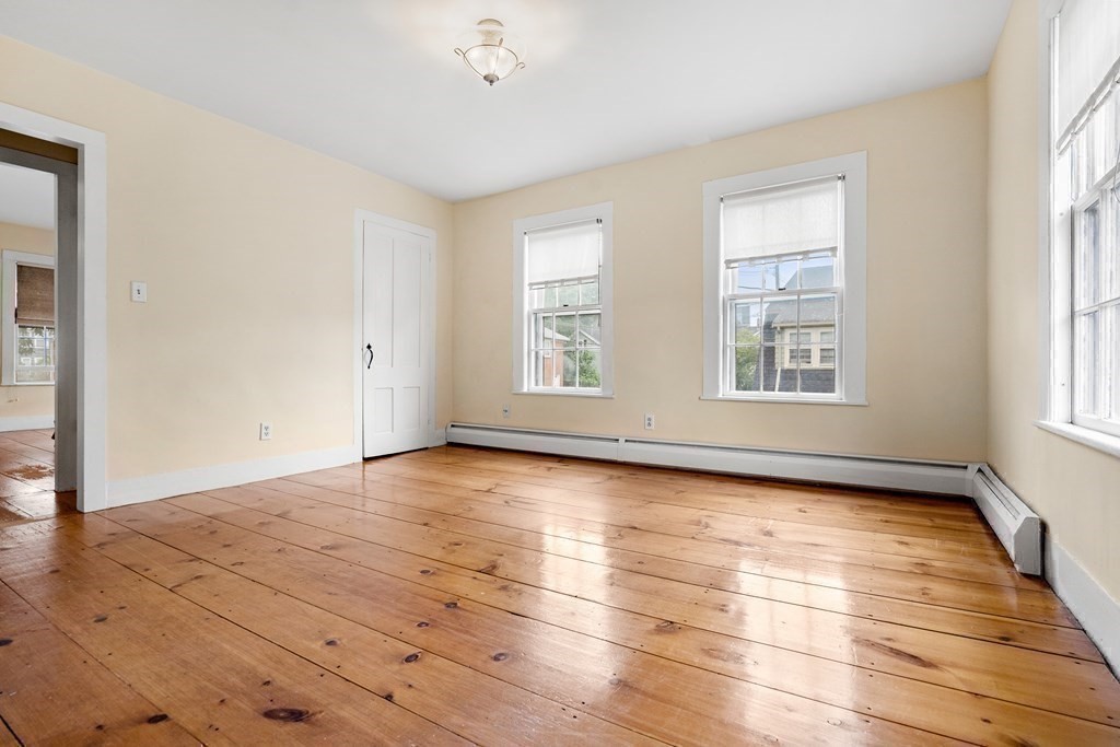 1 Red Frank Lane Marblehead, MA 01945 - Photo 24 of 32 an empty room with wooden floor and windows