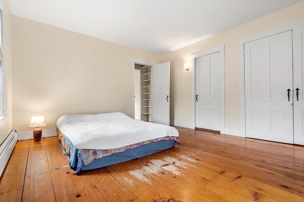 1 Red Frank Lane Marblehead, MA 01945 - Photo 27 of 32 a bedroom with a bed and wooden floor