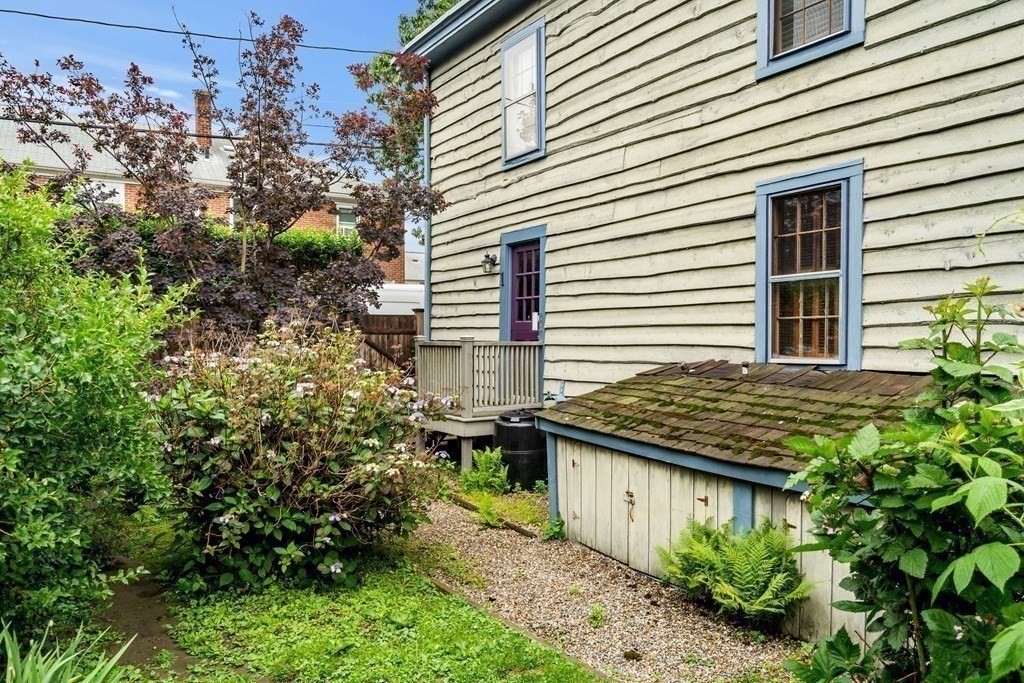 1 Red Frank Lane Marblehead, MA 01945 - Photo 6 of 32 a view of a backyard with plants and brick wall