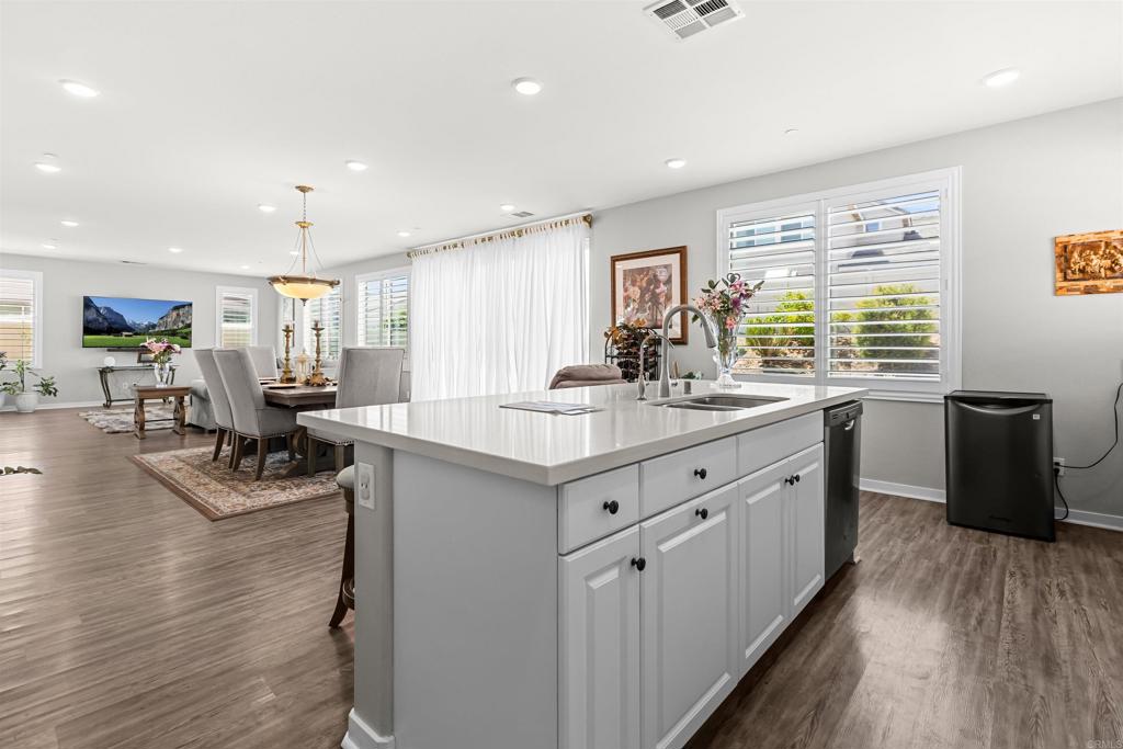 29809 Gypsy Vanner Way Menifee, CA 92584 - Photo 19 of 45 a kitchen with sink cabinets and wooden floor