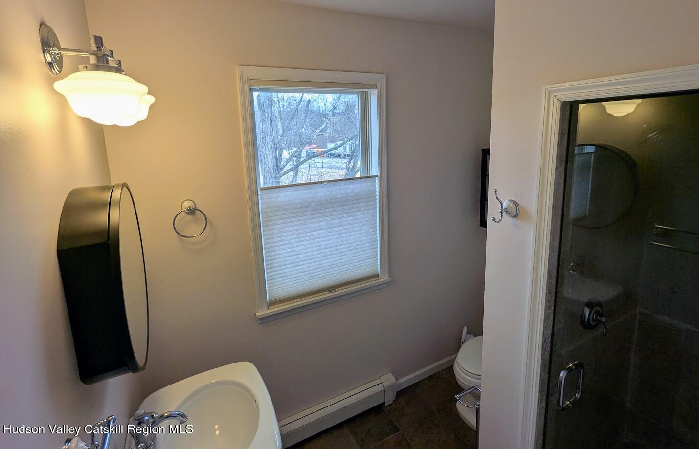 5359 Main Street, Unit 2H Windham, NY 12496 - Photo 18 of 22 a bathroom with a sink mirror and vanity