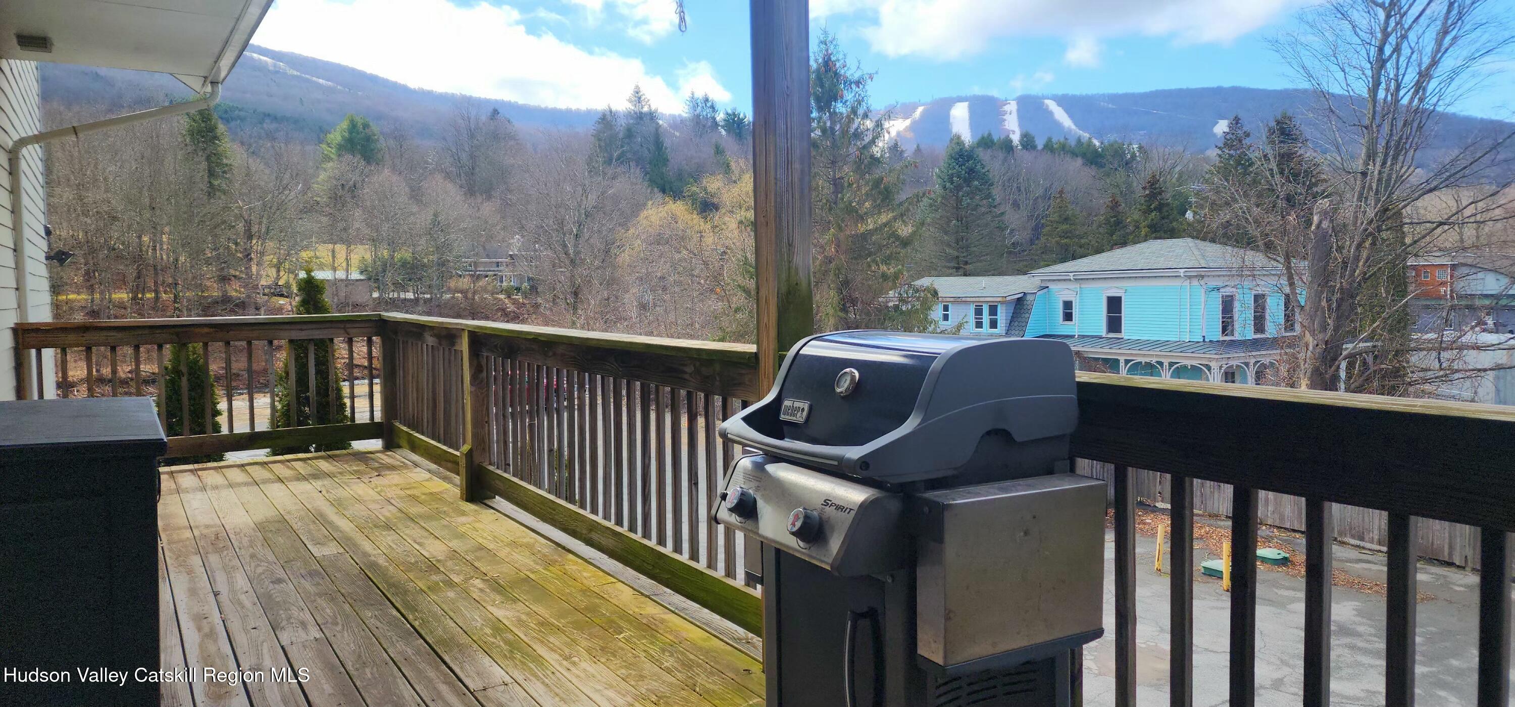 5359 Main Street, Unit 2H Windham, NY 12496 - Photo 3 of 22 a view of a roof deck with couches and wooden floor