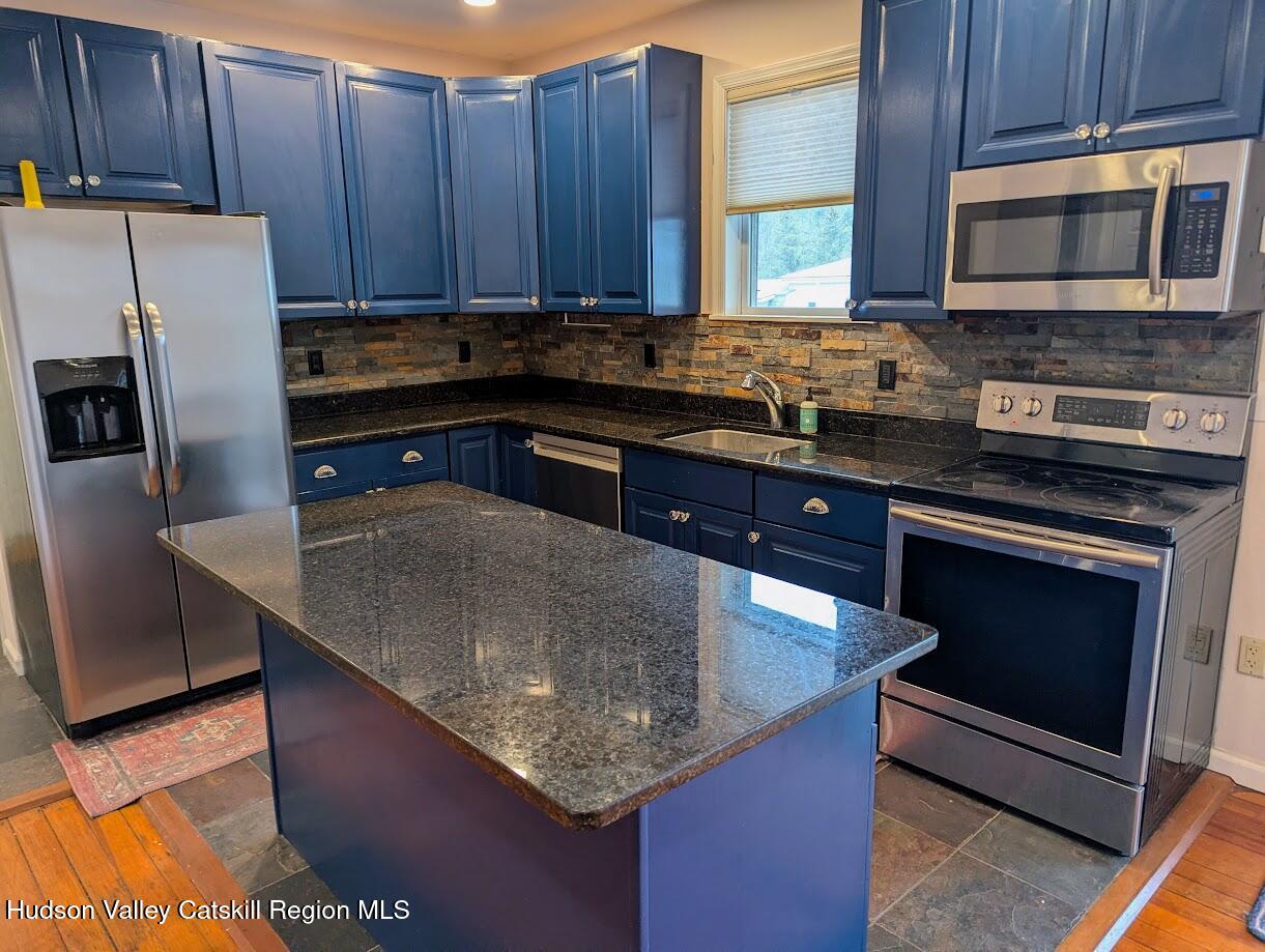 5359 Main Street, Unit 2H Windham, NY 12496 - Photo 4 of 22 a kitchen with granite countertop a stove microwave and refrigerator