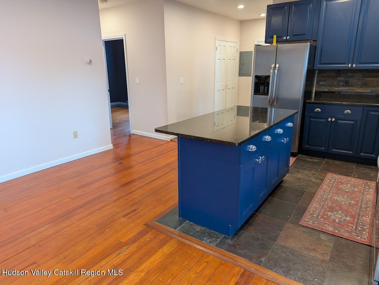 5359 Main Street, Unit 2H Windham, NY 12496 - Photo 7 of 22 a kitchen with stainless steel appliances a refrigerator and wooden cabinets