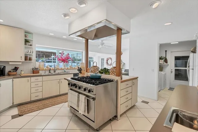 a kitchen with stainless steel appliances granite countertop a stove and a sink