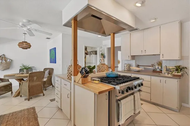 a kitchen that has a stove and a table in it
