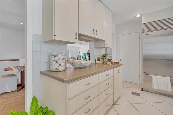 a kitchen with white cabinets and a sink