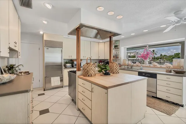 a kitchen with stainless steel appliances kitchen island granite countertop a sink and cabinets