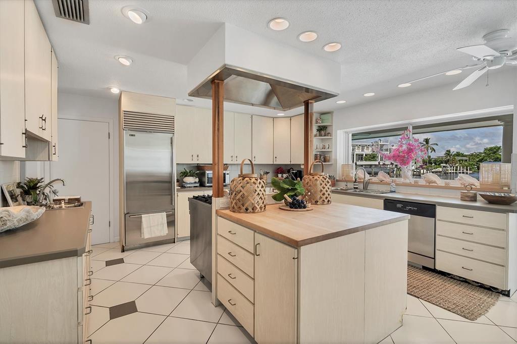 161 Damficare Street Boca Grande, FL 33921 - Photo 16 of 51 a kitchen with stainless steel appliances kitchen island granite countertop a sink and cabinets