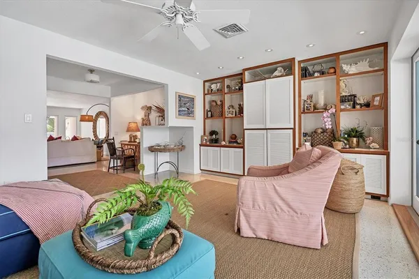 a living room with furniture and a potted plant
