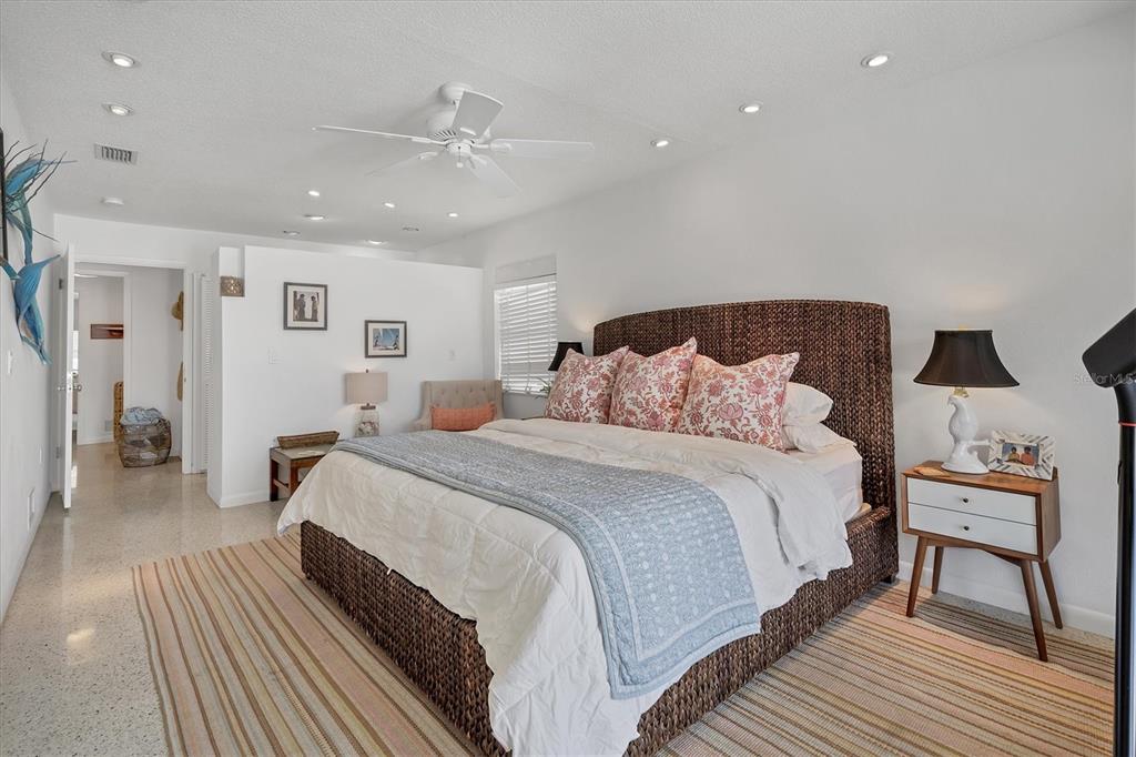161 Damficare Street Boca Grande, FL 33921 - Photo 24 of 51 a spacious bedroom with a bed and a table