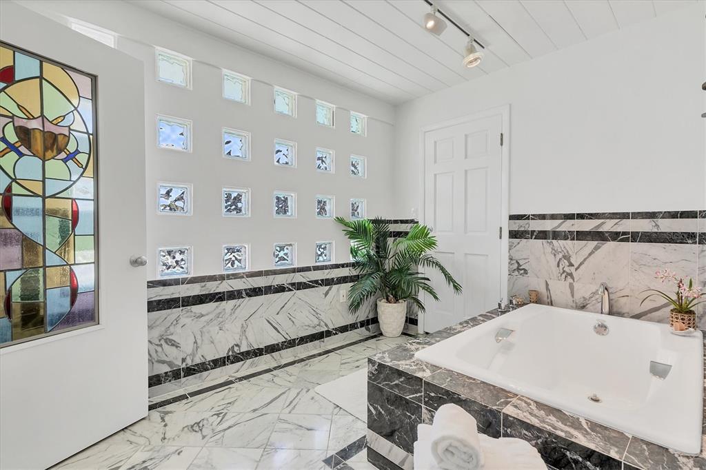 161 Damficare Street Boca Grande, FL 33921 - Photo 26 of 51 a spacious bathroom with a tub and sink