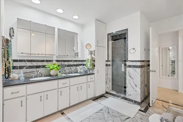 a kitchen with stainless steel appliances granite countertop a refrigerator and a sink