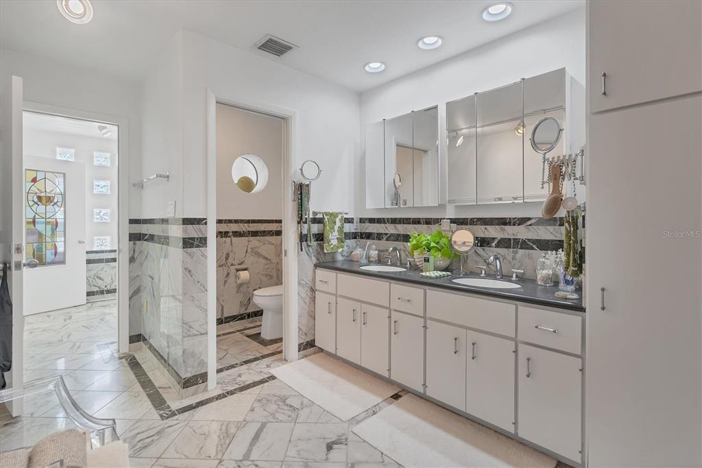 161 Damficare Street Boca Grande, FL 33921 - Photo 28 of 51 a large bathroom with a granite countertop sink and a mirror