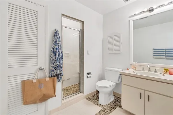 a bathroom with a sink toilet and shower