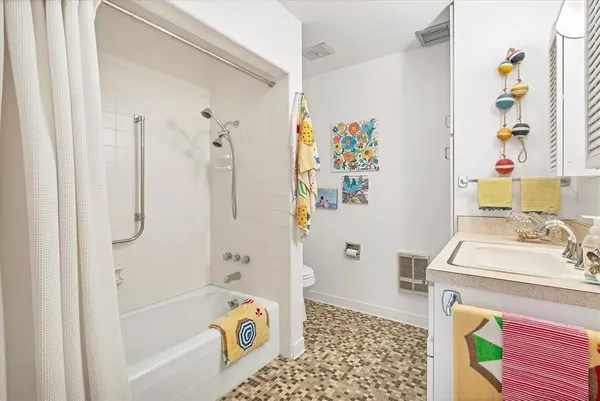 a bathroom with a sink toilet and shower