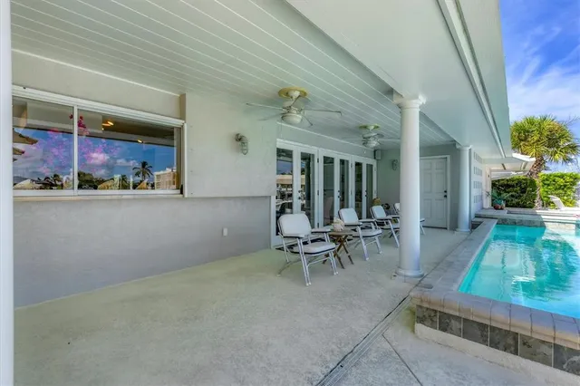 a view of a patio with table and chairs and potted plants
