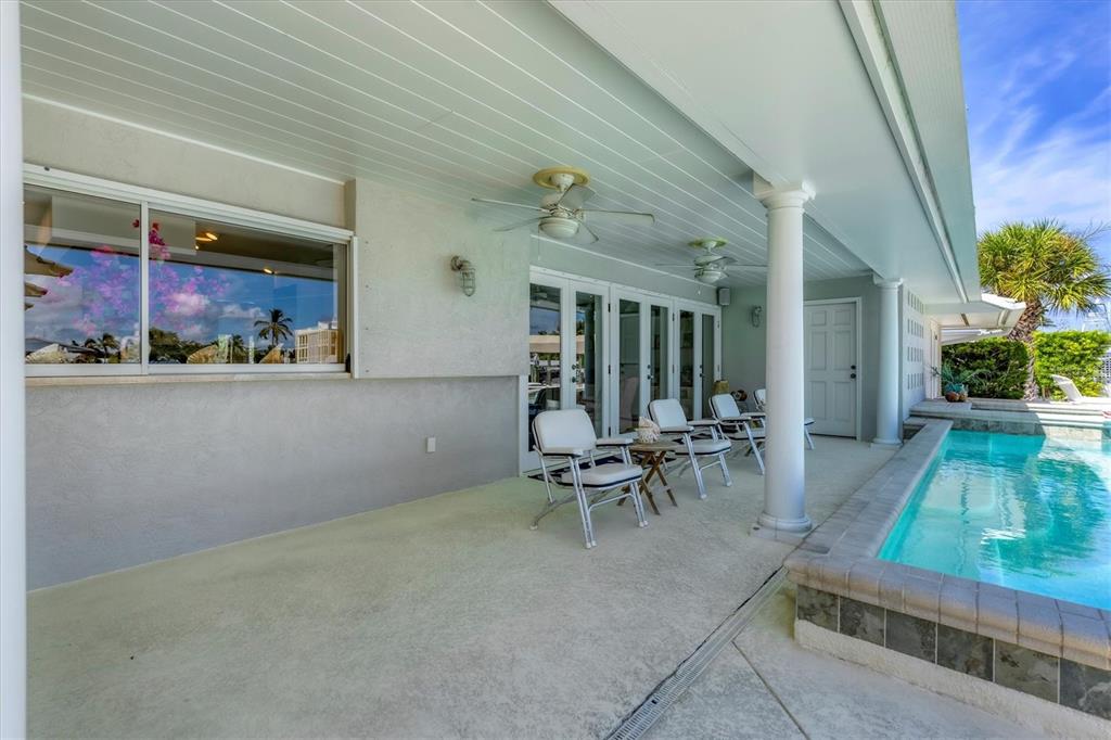 161 Damficare Street Boca Grande, FL 33921 - Photo 38 of 51 a view of a patio with table and chairs and potted plants