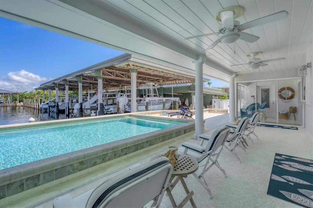 161 Damficare Street Boca Grande, FL 33921 - Photo 39 of 51 a view of a chairs and table in patio