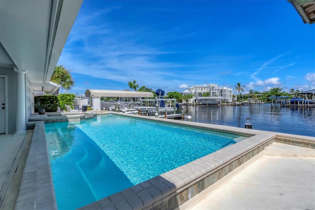 161 Damficare Street Boca Grande, FL 33921 - Photo 42 of 51 a view of a swimming pool with a patio
