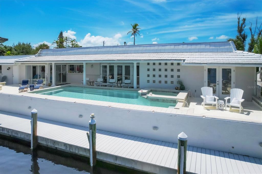 161 Damficare Street Boca Grande, FL 33921 - Photo 45 of 51 a porch with a table and chairs