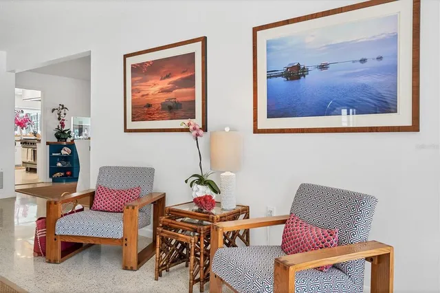 a living room with furniture and painting on the wall