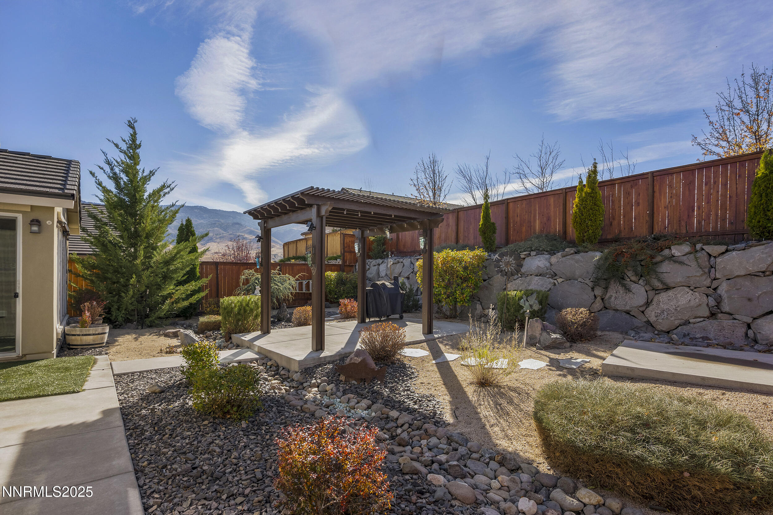 9165 Kenton Trail Reno, NV 89523 - Photo 12 of 22 a view of a backyard with plants and a patio