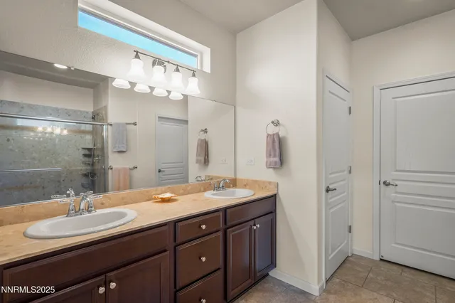 a bathroom with a sink double vanity and a mirror