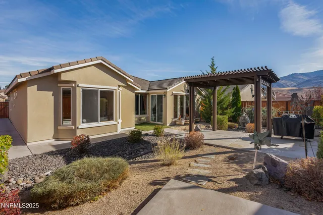 a front view of a house with garden and plants