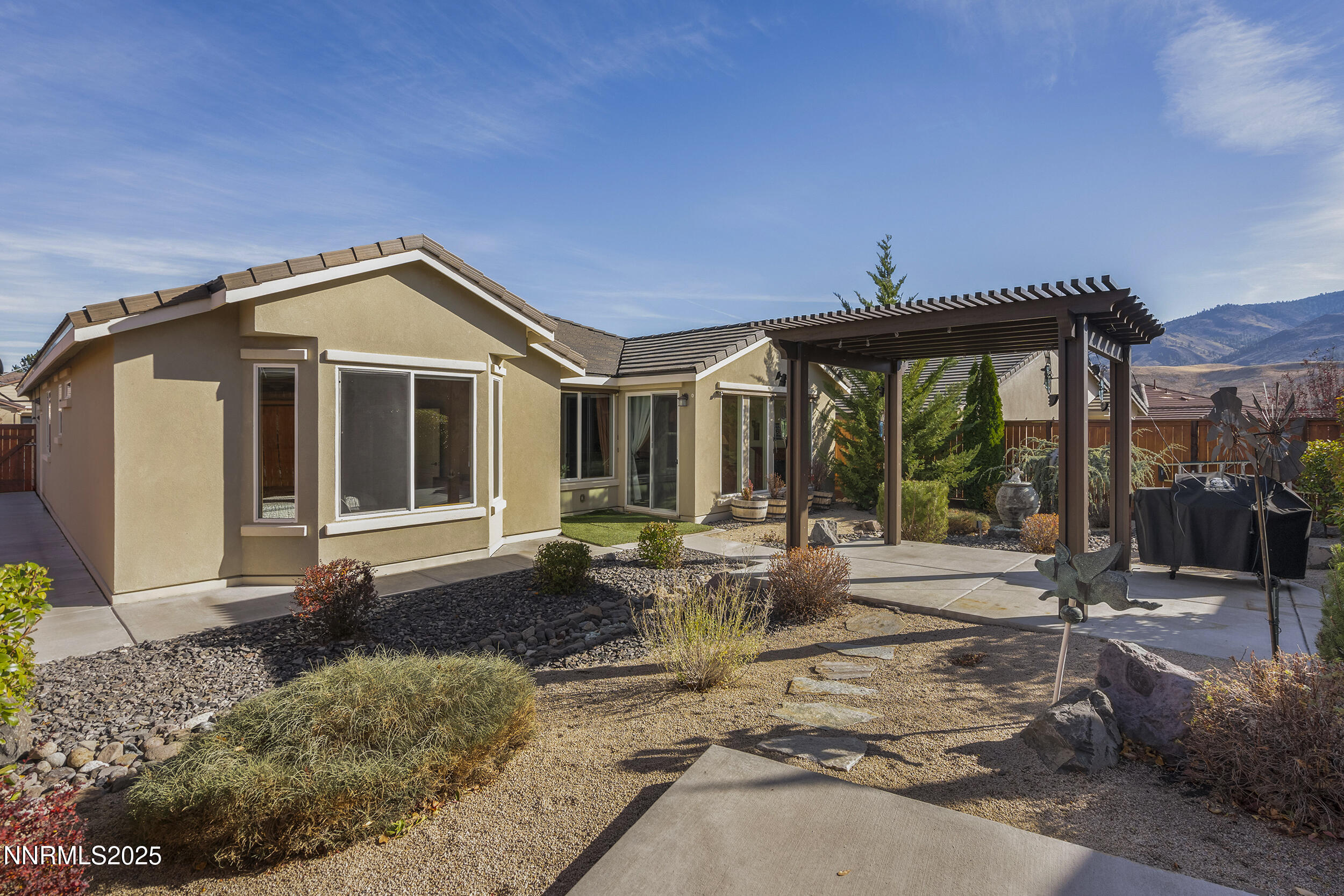 9165 Kenton Trail Reno, NV 89523 - Photo 4 of 22 a front view of a house with garden and plants