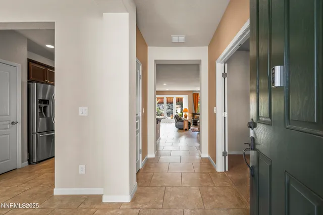 a view of a hallway with a livingroom and dining room space