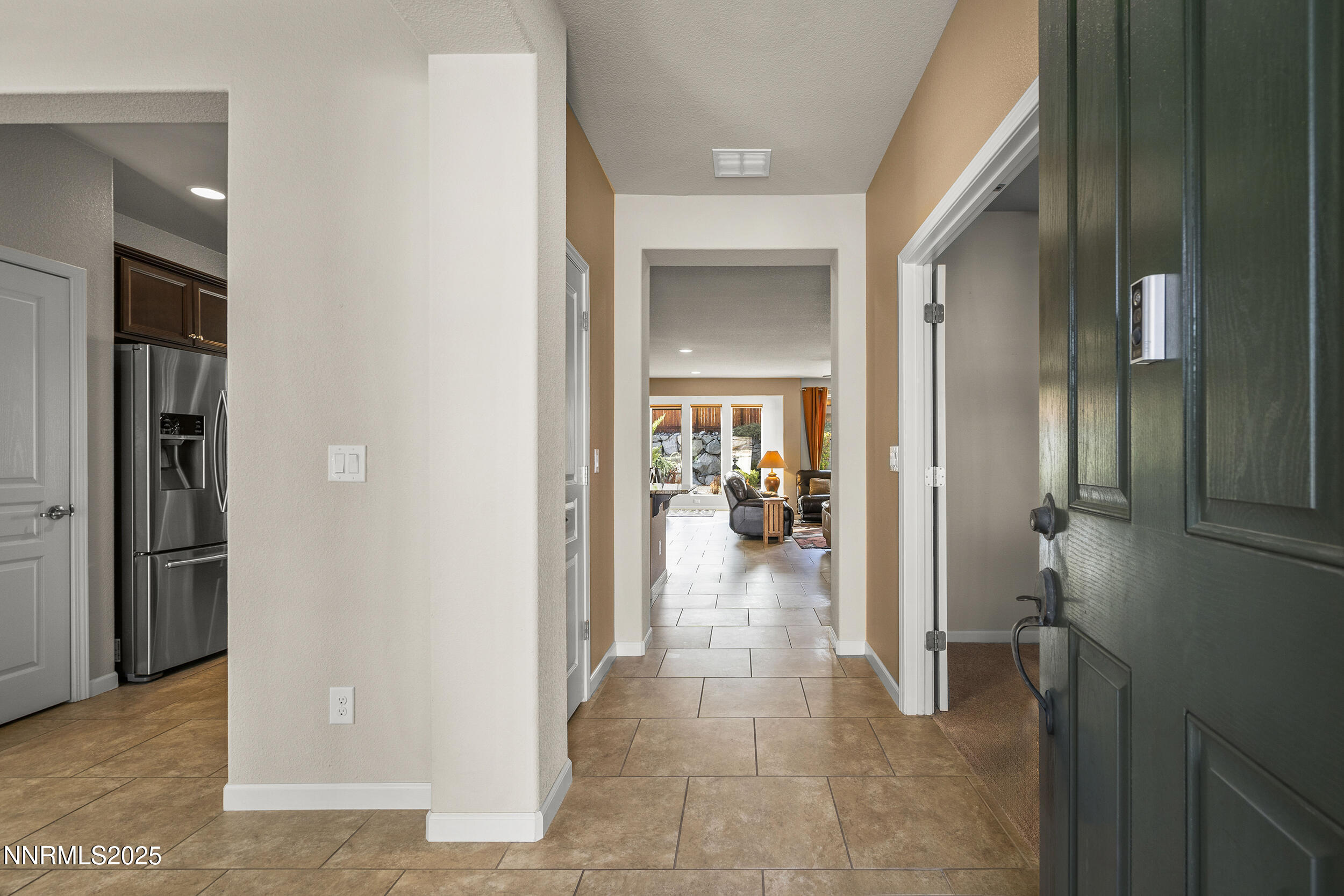 9165 Kenton Trail Reno, NV 89523 - Photo 6 of 22 a view of a hallway with a livingroom and dining room space