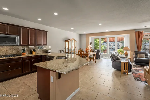 a kitchen with counter top space a sink a stove and cabinets