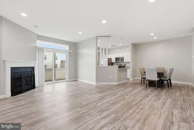 a view of kitchen with granite countertop cabinets and wooden floor