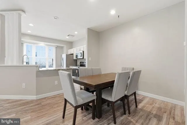 a view of a dining room with furniture and wooden floor