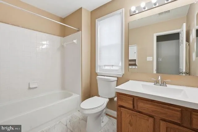 a bathroom with a sink a toilet a mirror and shower