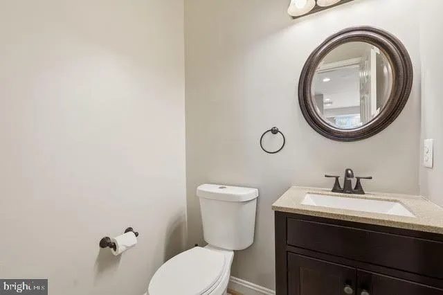 a bathroom with a toilet a sink and a mirror