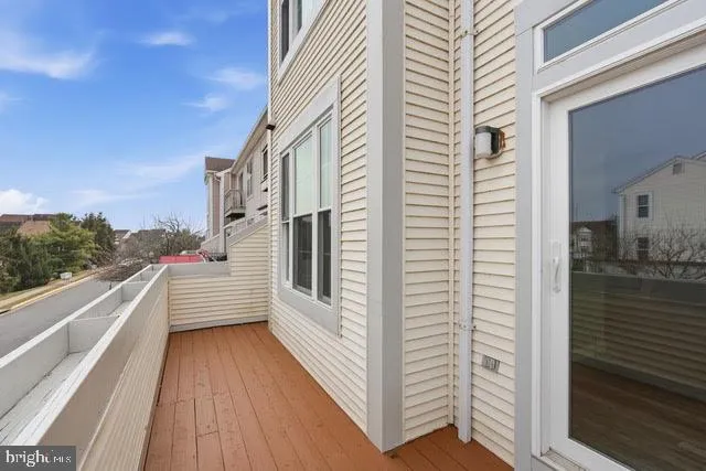 a view of a balcony with couch and wooden floor