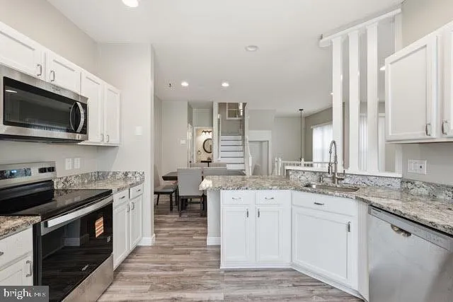 a kitchen with a sink stove and microwave