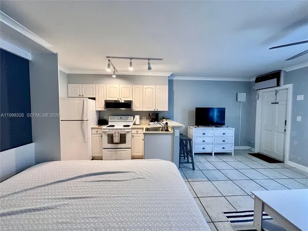 a kitchen with a white cabinets and white appliances
