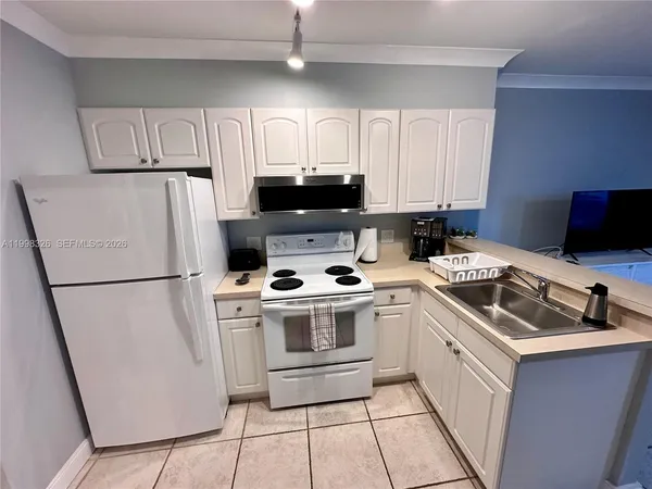 a kitchen with appliances and cabinets
