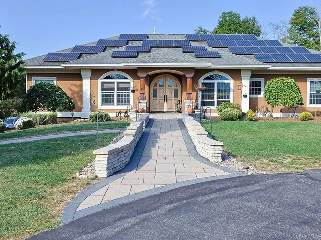 a front view of a house with garden
